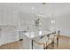 Bright, open kitchen featuring white cabinets, a large island, and modern lighting fixtures at 4812 Moonview Ln # 4, Sugar Hill, GA 30518