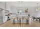 Bright, open kitchen featuring white cabinets, a large island, and modern lighting fixtures at 4812 Moonview Ln # 4, Sugar Hill, GA 30518