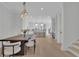 Open concept dining and living area with modern fixtures and bright kitchen at 4812 Moonview Ln # 4, Sugar Hill, GA 30518