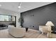 Contemporary living room featuring a dark accent wall and access to the outdoor deck at 4812 Moonview Ln # 4, Sugar Hill, GA 30518