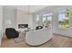 Cozy living room with fireplace, modern lighting, curved sofa, and windows that offer natural light and a scenic view at 4812 Moonview Ln # 4, Sugar Hill, GA 30518