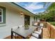 Outdoor dining area with a modern table and chairs on a wooden deck at 733 Pegg Sw Rd, Atlanta, GA 30315