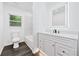 Bathroom features modern white cabinetry, updated vanity and fixtures, and tile shower at 733 Pegg Sw Rd, Atlanta, GA 30315