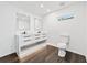 Bathroom features modern white cabinetry with double sink, wood floor, and recessed lights at 733 Pegg Sw Rd, Atlanta, GA 30315