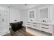 Sleek bathroom features a soaking tub, glass enclosed shower, and double sink vanity with modern mirrors at 733 Pegg Sw Rd, Atlanta, GA 30315