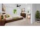 Bright bedroom features a ceiling fan, neutral walls, area rug, and wood furniture at 733 Pegg Sw Rd, Atlanta, GA 30315