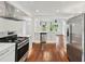 Bright kitchen with stainless appliances, white cabinetry, and hardwood floors at 733 Pegg Sw Rd, Atlanta, GA 30315