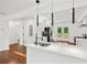 Modern kitchen features stainless steel appliances, quartz countertops, and hardwood floors at 733 Pegg Sw Rd, Atlanta, GA 30315