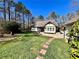 Spacious backyard with lush lawn, mature trees, garden beds, and ample space for outdoor activities at 1049 Panola Rd, Ellenwood, GA 30294