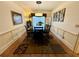 Dining room with hardwood floors, a table and chairs, and updated lighting at 1049 Panola Rd, Ellenwood, GA 30294