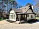 Beautiful home featuring a brick facade, covered porch, manicured landscaping, and inviting curb appeal at 1049 Panola Rd, Ellenwood, GA 30294