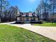 Charming home featuring three dormers, brick exterior, covered porch, manicured lawn, and an inviting front entrance at 1049 Panola Rd, Ellenwood, GA 30294