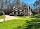 Charming home featuring three dormers, brick exterior, covered porch, manicured lawn, and an inviting front entrance at 1049 Panola Rd, Ellenwood, GA 30294