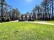 Charming home featuring three dormers, brick exterior, covered porch, manicured lawn, and an inviting front entrance at 1049 Panola Rd, Ellenwood, GA 30294