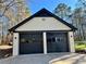 Two-car garage with modern doors, exterior lighting, and convenient access to the property at 1049 Panola Rd, Ellenwood, GA 30294