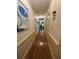 A long hallway with hardwood floors, neutral paint, and classic trim at 1049 Panola Rd, Ellenwood, GA 30294