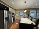An airy kitchen shows stainless steel appliances, a breakfast bar, and hardwood floors at 1049 Panola Rd, Ellenwood, GA 30294