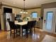 A sunny kitchen displays a breakfast bar island, stainless steel appliances, and ample cabinetry at 1049 Panola Rd, Ellenwood, GA 30294
