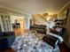 Comfortable living room with hardwood floors, staircase, and plenty of natural light at 1049 Panola Rd, Ellenwood, GA 30294