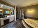 Luxurious main bathroom with a soaking tub, double vanity, and a glass enclosed shower at 1049 Panola Rd, Ellenwood, GA 30294