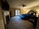 A spacious main bedroom has carpeted floors, neutral walls, and a fireplace at 1049 Panola Rd, Ellenwood, GA 30294