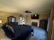 Spacious main bedroom featuring a fireplace, dresser, and ceiling fan, perfect for relaxation at 1049 Panola Rd, Ellenwood, GA 30294