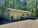 Outbuilding with plenty of gravel driveway and space for parking at 1049 Panola Rd, Ellenwood, GA 30294