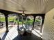Covered outdoor patio with seating and ceiling fan, perfect for entertaining and relaxing at 1049 Panola Rd, Ellenwood, GA 30294