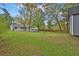 Expansive backyard showing a white house, green lawn, and partial view of the storage shed at 1531 Piedmont Ne Rd, Marietta, GA 30066