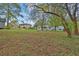 Spacious backyard with lush greenery, a glimpse of the house, and convenient storage shed at 1531 Piedmont Ne Rd, Marietta, GA 30066