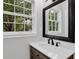 Updated bathroom vanity featuring marble countertop, an ornate mirror and bright natural light at 1531 Piedmont Ne Rd, Marietta, GA 30066