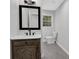 Bathroom featuring updated vanity, marble countertop, an elegant mirror and bright natural light at 1531 Piedmont Ne Rd, Marietta, GA 30066