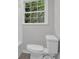 Bathroom featuring white toilet, bright natural light, and neutral paint at 1531 Piedmont Ne Rd, Marietta, GA 30066