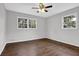 Bright bedroom featuring hardwood floors, neutral walls, and a ceiling fan at 1531 Piedmont Ne Rd, Marietta, GA 30066