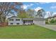 Charming ranch-style home with a well-manicured front yard and attached two-car garage at 1531 Piedmont Ne Rd, Marietta, GA 30066