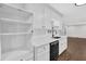 Stylish kitchen with open shelving, black sink fixtures, and stainless steel appliances at 1531 Piedmont Ne Rd, Marietta, GA 30066