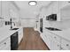 Spacious kitchen with black appliances, marble countertops, and view to living room at 1531 Piedmont Ne Rd, Marietta, GA 30066