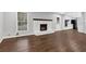 Cozy living room featuring a white-brick fireplace, hardwood floors, and plenty of natural light at 1531 Piedmont Ne Rd, Marietta, GA 30066