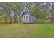 Backyard gray storage shed with white trim offers ample space for storing tools or equipment at 1531 Piedmont Ne Rd, Marietta, GA 30066