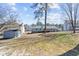 Spacious backyard with a shed and view of the home's exterior and inviting backyard with some trees at 2003 Graystone Pkwy, Grayson, GA 30017