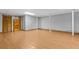 Finished basement with laminate flooring, columns, and doors at 2003 Graystone Pkwy, Grayson, GA 30017