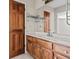 Bathroom with single sink, wooden cabinet, and a large mirror at 2003 Graystone Pkwy, Grayson, GA 30017