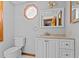 Well-lit bathroom features an octagonal window, vanity, mirror, and toilet at 2003 Graystone Pkwy, Grayson, GA 30017