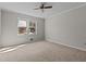 Neutral bedroom with a ceiling fan and a sun-filled window at 2003 Graystone Pkwy, Grayson, GA 30017