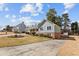 View of the home's exterior with blue siding, manicured landscaping, an extra-wide driveway, and a two-car garage at 2003 Graystone Pkwy, Grayson, GA 30017