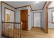 Bright foyer with wooden door, staircase, and light hardwood floors creating a warm entrance at 2003 Graystone Pkwy, Grayson, GA 30017