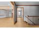 Inviting home hallway with light wood floors, staircase and trim, leading to adjacent rooms at 2003 Graystone Pkwy, Grayson, GA 30017