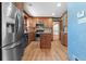 Spacious kitchen featuring stainless steel appliances, wooden cabinetry, and tile backsplash at 2003 Graystone Pkwy, Grayson, GA 30017