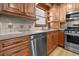 Kitchen showcasing stainless steel dishwasher and oven with wooden cabinets at 2003 Graystone Pkwy, Grayson, GA 30017