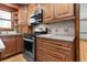 Updated kitchen showcasing stainless steel oven, granite countertops, and wooden cabinetry at 2003 Graystone Pkwy, Grayson, GA 30017